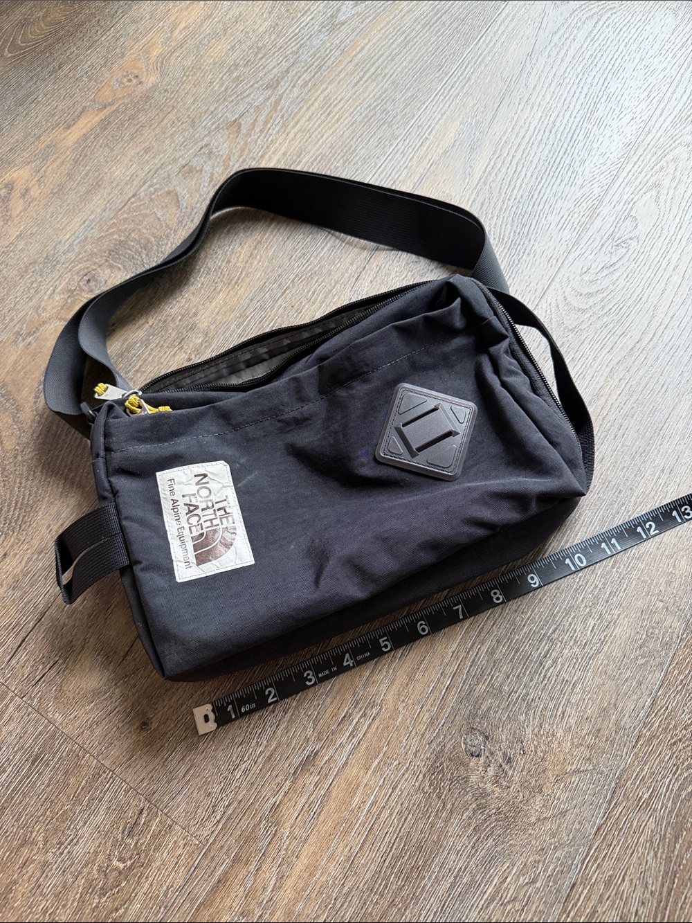 The North Face Black Waist Sling Bag with Yellow Accents